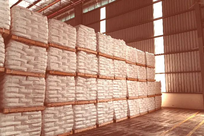 a warehouse filled with stacks of white bags